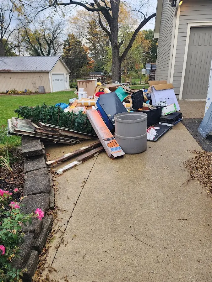Dumpster being loaded with debris for Estate Cleanout Dumpster Rental in Isle of Palms
